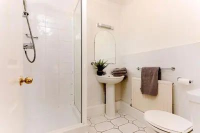 a bathroom with a toilet sink and a shower at Beau Vista GF in Padstow