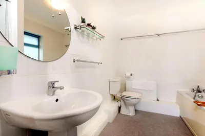 a bathroom with a sink and a toilet and a mirror at Beau Vista FF in Padstow