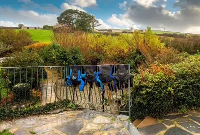 a group of parking meters attached to a fence at Primrose Cottage in St Merryn