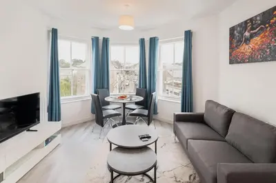 a living room with a couch and a table at Trehawke House in Liskeard