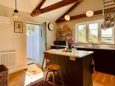 a kitchen with a sink and a counter top at The Dairy - Luxurious Hideaway on The Lizard in Cury