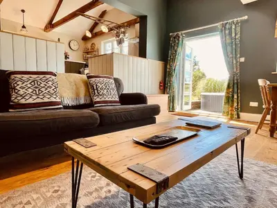 a living room with a couch and a coffee table at The Dairy - Luxurious Hideaway on The Lizard in Cury