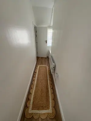 a hallway with a floor mat in the middle of a room at Bagnalls Cottage, A newly renovated cottage in the heart of the Downalong, St Ives moments from the harbour beach in St Ives
