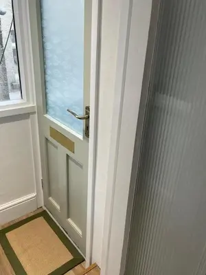 a door with a window and a mat in front of it at Bagnalls Cottage, A newly renovated cottage in the heart of the Downalong, St Ives moments from the harbour beach in St Ives