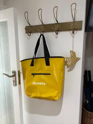 a yellow shopping bag hanging on a wall at Bagnalls Cottage, A newly renovated cottage in the heart of the Downalong, St Ives moments from the harbour beach in St Ives