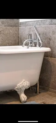 a white bathroom sink with a fish foot under it at 3 Bed Stylish Beachfront Retreat in Roche