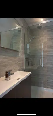 a bathroom with a shower with a sink and a shower at 3 Bed Stylish Beachfront Retreat in Roche