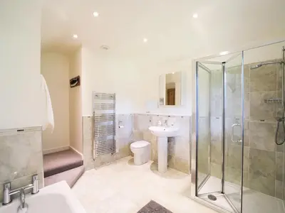 a bathroom with a shower and a toilet and a sink at Polmear Farm House in Charlestown
