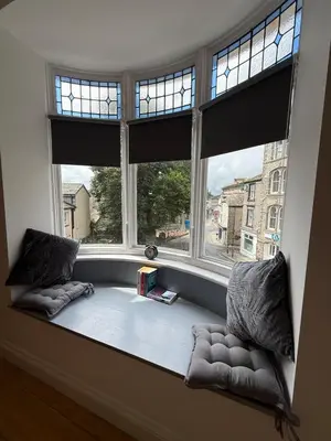 a window seat in a room with two large windows at Modern Town Centre Flat in St Austell