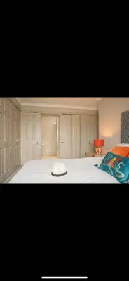 a bedroom with a bed with a hat on it at FERRYPOINT - 3 Bed Stylish Beachfront Retreat in Padstow