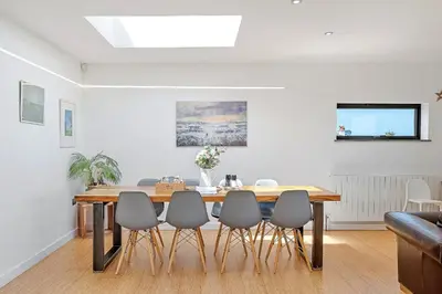 a dining room with a table and chairs at Finest Retreats - Tregarden in Bude