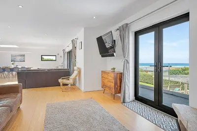 a living room with a couch and a view of the ocean at Finest Retreats - Tregarden in Bude