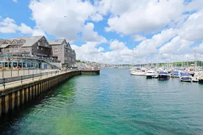 a marina with boats in the water and buildings at Finest Retreats - Lansdowne in Falmouth