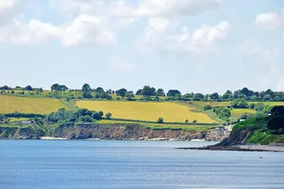 a view of a large body of water with green fields at Finest Retreats - Lansdowne in Falmouth