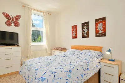 a bedroom with a bed and a flat screen tv at Finest Retreats - Lansdowne in Falmouth