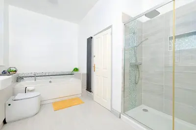 a bathroom with a tub and a toilet and a shower at Finest Retreats - Lansdowne in Falmouth