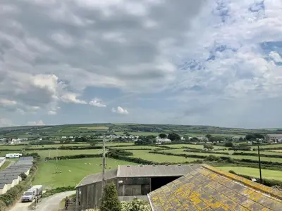 a view of a farm with a building and a field at Pendrin Guest House in Tintagel