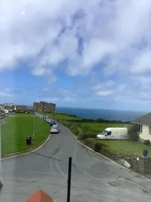 a street with cars parked on the side of a road at Pendrin Guest House in Tintagel