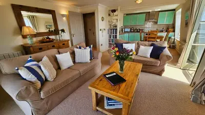 a living room with a couch and a table at Crow's Nest in Saint Mawes
