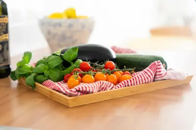 a wooden tray filled with vegetables on a table at 15 Barnaloft in St Ives