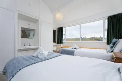 a hotel room with two beds and a window at 15 Barnaloft in St Ives