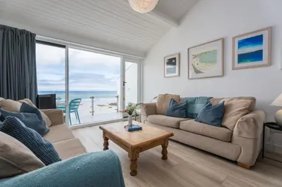 a living room with a couch and a table at 17 Barnaloft in St Ives