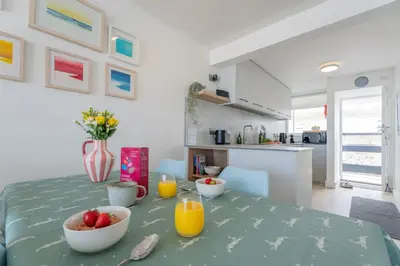 a dining room table with a bowl of fruit on it at 17 Barnaloft in St Ives