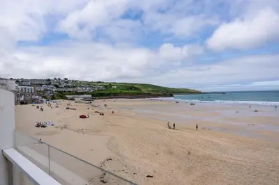 a group of people on a beach near the ocean at 17 Barnaloft in St Ives