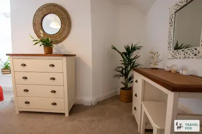 a bedroom with a dresser and a mirror at The Bird's Nest - Free Parking! in Boscastle