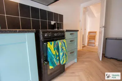 a kitchen with a black stove top oven in a room at The Bird's Nest - Free Parking! in Boscastle