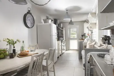 a kitchen with white appliances and a table and chairs at Almond Cottage - Pets welcome - Free Parking - Garden in Hayle