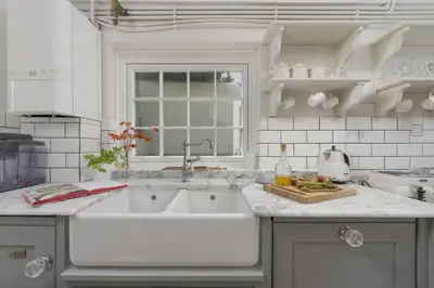 a white kitchen with a sink and a window at Almond Cottage - Pets welcome - Free Parking - Garden in Hayle