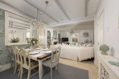 a dining room with a table and a bed at Almond Cottage - Pets welcome - Free Parking - Garden in Hayle