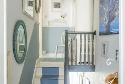 a staircase in a home with blue and white walls at Almond Cottage - Pets welcome - Free Parking - Garden in Hayle