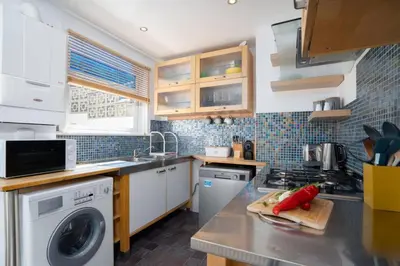 a kitchen with a sink and a stove top oven at Trewirgie in St Ives
