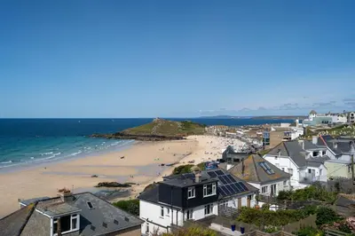 a view of a beach with houses and the ocean at Trewirgie in St Ives