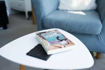 a book sitting on top of a white coffee table at Trewirgie in St Ives