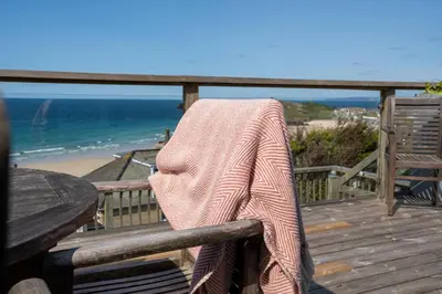 a towel is sitting on a chair on a wooden boardwalk gmaxwell gmaxwellzosktop at Trewirgie in St Ives