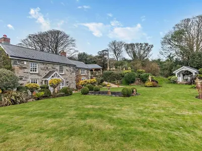 an old stone house with a large yard at Rose Cottage in Saint Hilary