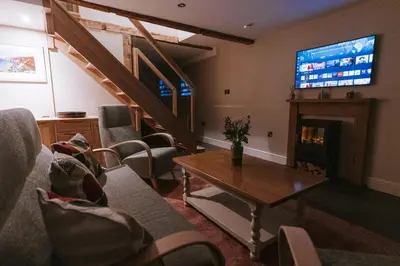 a living room with a couch and a tv at Bluck's cottage in St. Agnes