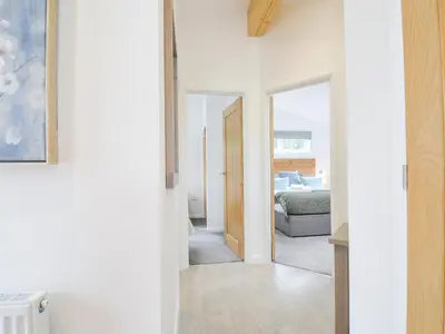 a room with a door leading to a bedroom at 3 Meadow Retreat in Liskeard