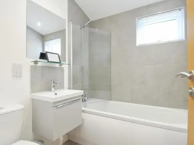 a bathroom with a tub and a sink and a toilet at 3 Meadow Retreat in Liskeard