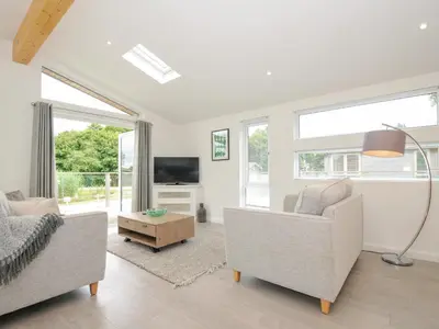 a living room with two couches and a tv at 3 Meadow Retreat in Liskeard