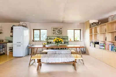 a kitchen with a table and a refrigerator at The Birch House in Saint Columb Major