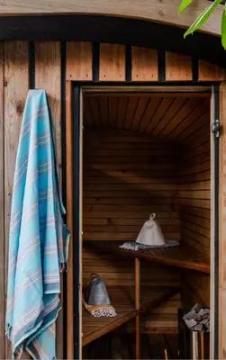 a sauna with a umbrella and hats on shelves at The Birch House in Saint Columb Major
