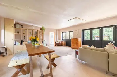 a living room with a couch and a table at The Birch House in Saint Columb Major