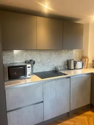 a kitchen with a microwave and a counter top at Honeysuckle Cottage in St. Agnes