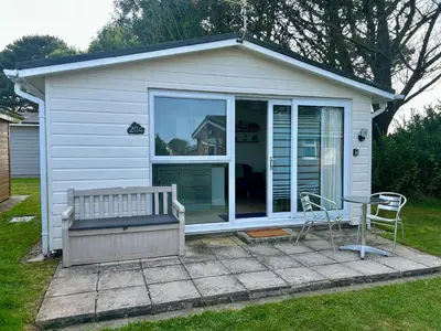 a small house with a bench and a table at 204 Atlantic Bays, St Merryn in St Merryn