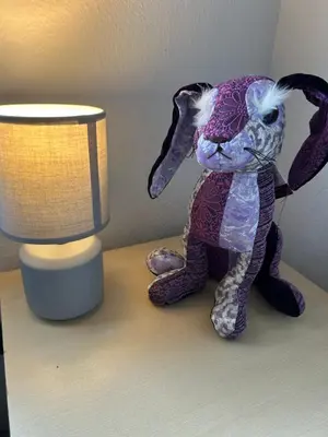 a stuffed rabbit sitting on a table next to a lamp at 204 Atlantic Bays, St Merryn in St Merryn