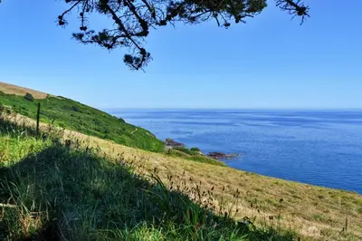 a view of the ocean from a hill at Finest Retreats - The Old Vicarage in Talland